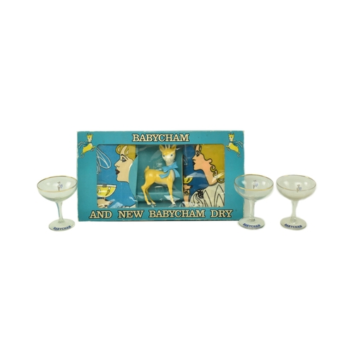 53 - Babycham - a vintage Babycham advertising gift set, along with three coupe wine glasses. The gift se... 