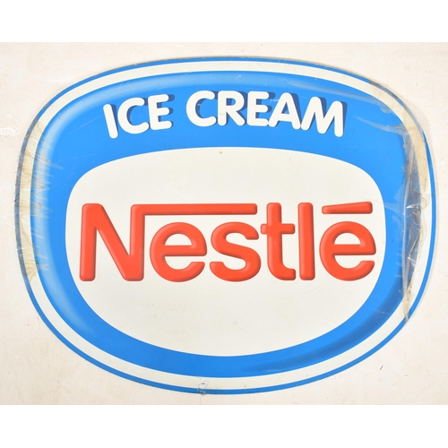 72 - Nestle - a collection of three vintage late 20th & 21st century point of advertising signboards. The... 