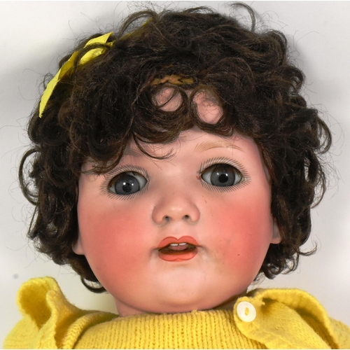 259 - Dolls - a vintage German bisque headed doll. Brown flirty eyes, finely painted brows and lashes and ... 