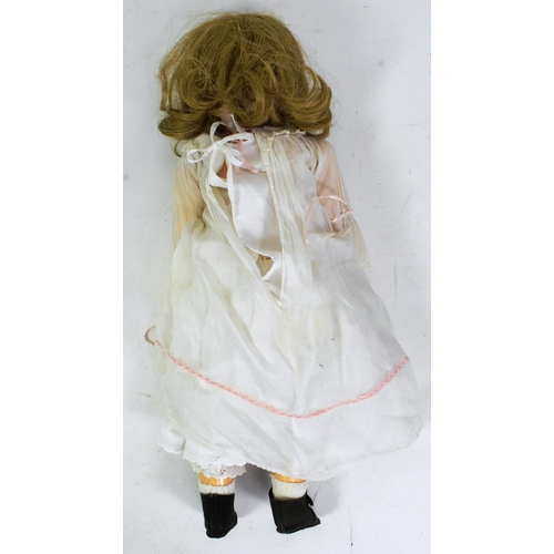 280 - An early 20th Century German ' Kley & Hahn ' bisque headed doll . Brown flirty eyes, finely panted b... 