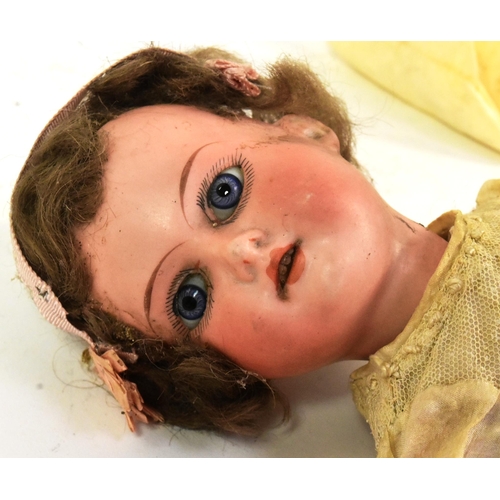 318 - An early 20th Century German Armand Marseille bisque headed doll. Blue fixed eyes, finely painted br... 