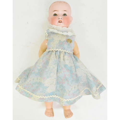 363 - An early 20th Century German Heubach Koppelsdorf made bisque headed doll. Blue fixed eyes, finely pa... 