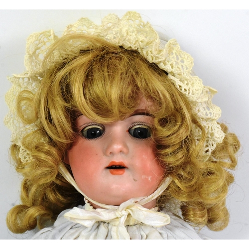 369 - A vintage German made bisque headed character doll. Blue flirty eyes, finely painted brows and lashe... 