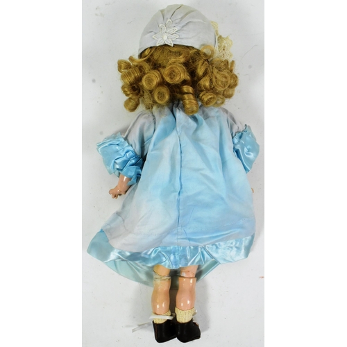 369 - A vintage German made bisque headed character doll. Blue flirty eyes, finely painted brows and lashe... 