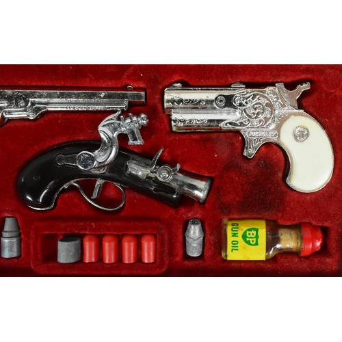 521 - A vintage 1960s BCM Company (Derby) Outlaw Presentation Case of Miniature Antique Firearms. The set ... 