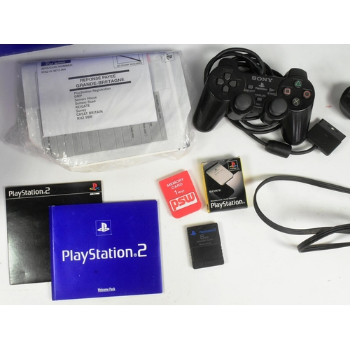 526 - Retro Gaming - an original Sony PS2 Playstation 2 video game console together with controllers and P... 