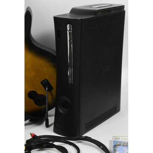 529 - Gaming - an Xbox 360 in black, along with a selection of Xbox controllers, along with a boxed Ninten... 