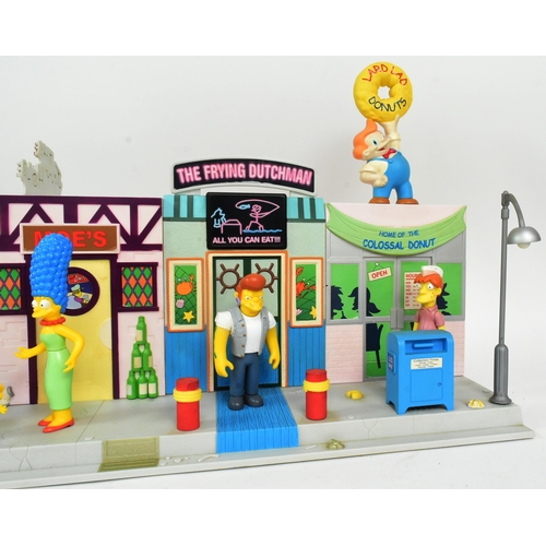 542 - The Simpsons - Playmates - a Simpsons 'Main Street' interactive playset, featuring the main street a... 