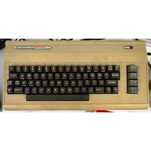 587 - Retro Gaming - a collection of vintage video game consoles comprising; 1980s Commodore 64 / C64 home... 