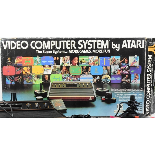 596 - Retro Gaming - an original vintage Atari CX-2600 video game console. The boxed set containing x4 gam... 