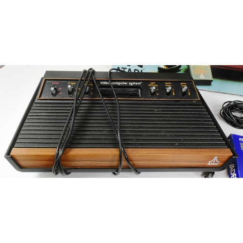 596 - Retro Gaming - an original vintage Atari CX-2600 video game console. The boxed set containing x4 gam... 