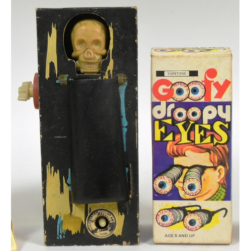 617 - A collection of vintage 1970s / 80s novelty toys comprising; Coffin Bank (working), Goofy Droopy Eye... 