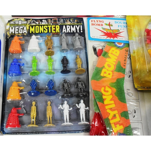 717 - A collection of vintage childrens rack pack toys to include; Doctor Who Mega Monster Army, Smokey Be... 