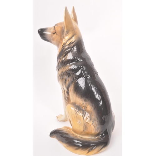 10 - Beswick - A vintage 20th century ceramic Alsatian / German shepherd dog figurine. In a seated positi... 