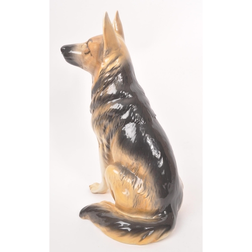 10 - Beswick - A vintage 20th century ceramic Alsatian / German shepherd dog figurine. In a seated positi... 
