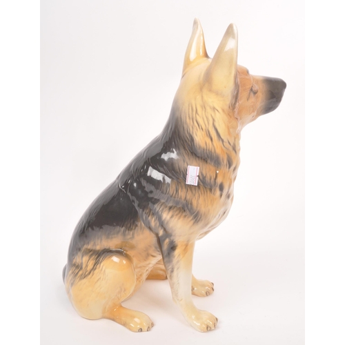 10 - Beswick - A vintage 20th century ceramic Alsatian / German shepherd dog figurine. In a seated positi... 