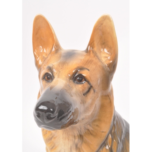 10 - Beswick - A vintage 20th century ceramic Alsatian / German shepherd dog figurine. In a seated positi... 