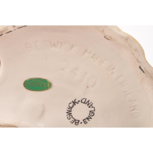 10 - Beswick - A vintage 20th century ceramic Alsatian / German shepherd dog figurine. In a seated positi... 