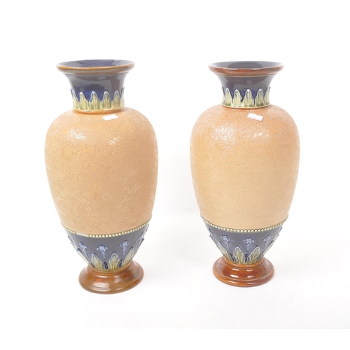 15 - Royal Doulton - Lambeth - A pair of 19th century ceramic pottery table vases. Having a flared rim wi... 