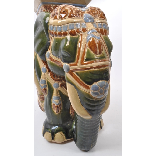 19 - Large green majolica style Indian elephant with pedestal with a square pedestal to its back above pi... 
