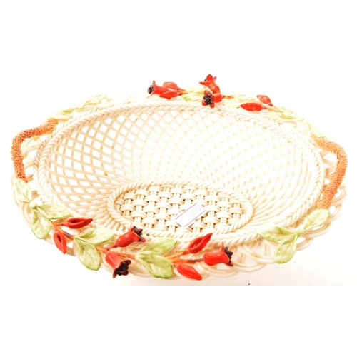 2 - Belleek - Irish Porcelain - An early 20th century woven fuchsia basket. With intricate weave detail,... 