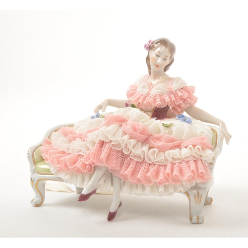 24 - Dresden - Late 20th century Crinoline lady with fine lace decoration sat upon a regency period parlo... 