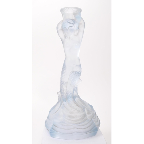 26 - An Art Deco blue glass dressing table set with floral scroll decoration, the candlesticks with merma... 