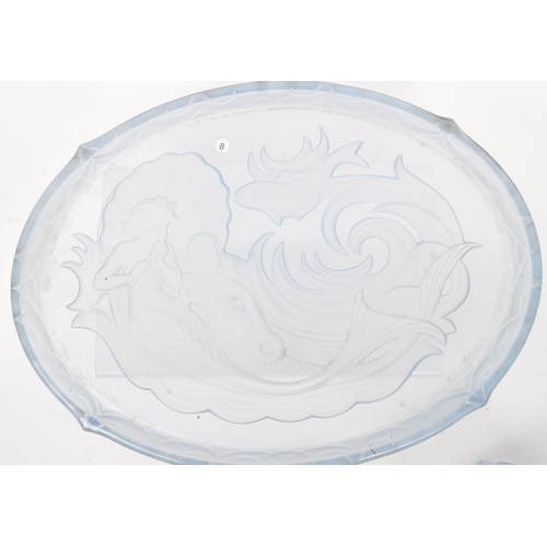 26 - An Art Deco blue glass dressing table set with floral scroll decoration, the candlesticks with merma... 