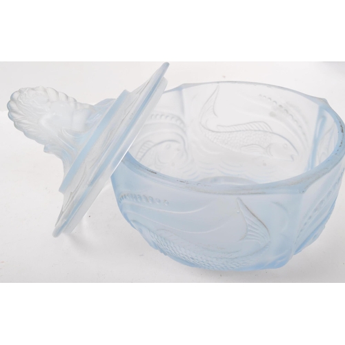 26 - An Art Deco blue glass dressing table set with floral scroll decoration, the candlesticks with merma... 