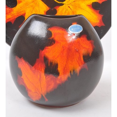 31 - Poole Pottery - A forest flame purse table top vase, together with matching pattern large wall / dis... 