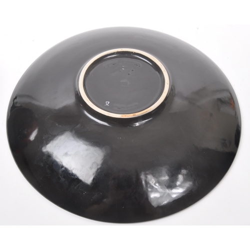 31 - Poole Pottery - A forest flame purse table top vase, together with matching pattern large wall / dis... 