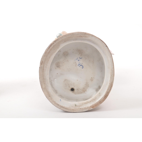 39 - A pair of 20th century Meissen manner German Continental porcelain figures. The figures, one of a la... 