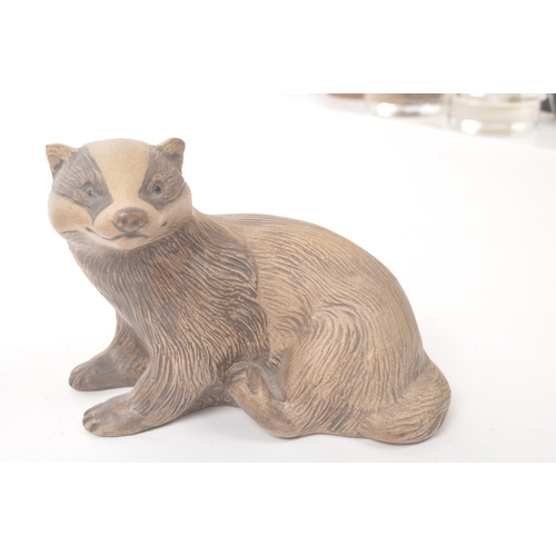 41 - Poole pottery - 20th century - A large hand made figure of a fawn and two smaller figure badgers wit... 