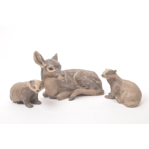 41 - Poole pottery - 20th century - A large hand made figure of a fawn and two smaller figure badgers wit... 