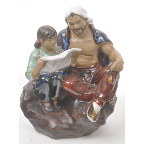 50 - A collection of four Chinese ceramic mud men figurines. Each of the figures on naturalistic bases, w... 