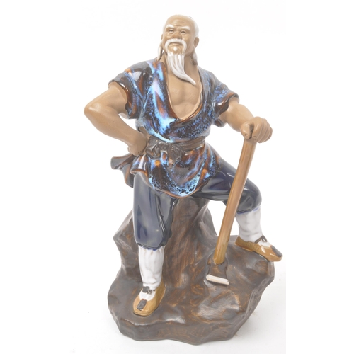 50 - A collection of four Chinese ceramic mud men figurines. Each of the figures on naturalistic bases, w... 