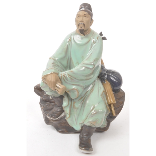 50 - A collection of four Chinese ceramic mud men figurines. Each of the figures on naturalistic bases, w... 