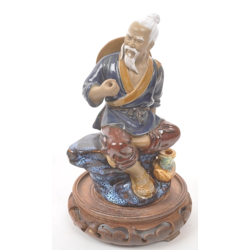 50 - A collection of four Chinese ceramic mud men figurines. Each of the figures on naturalistic bases, w... 