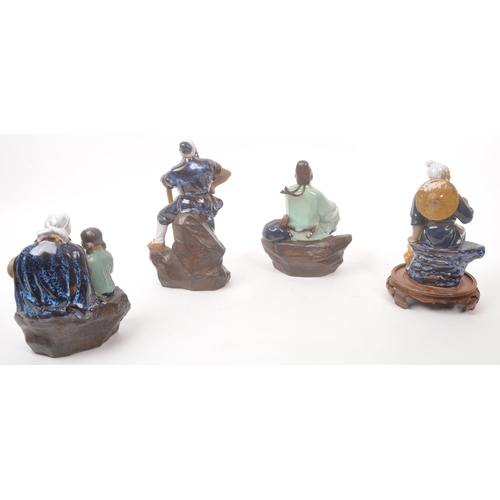 50 - A collection of four Chinese ceramic mud men figurines. Each of the figures on naturalistic bases, w... 