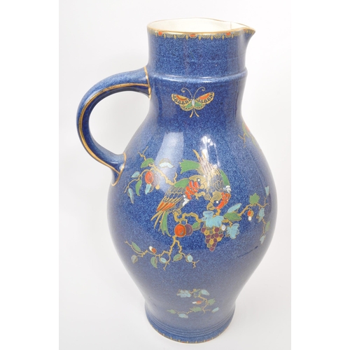 9 - A large 20th century Crown Pottery Bursley Ware Selah pattern jug. The jug having blue glaze with pa... 