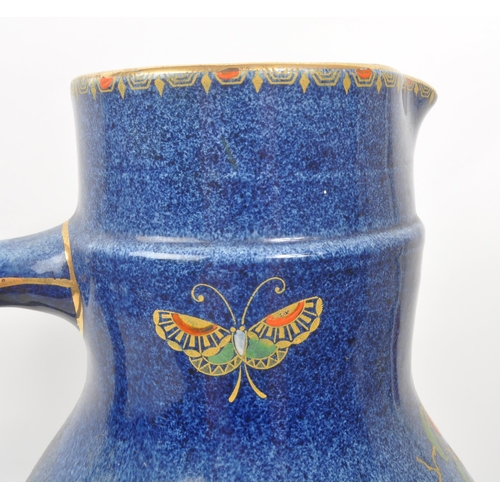 9 - A large 20th century Crown Pottery Bursley Ware Selah pattern jug. The jug having blue glaze with pa... 