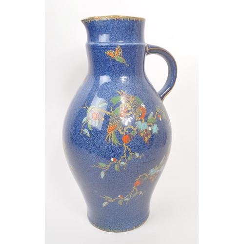 9 - A large 20th century Crown Pottery Bursley Ware Selah pattern jug. The jug having blue glaze with pa... 