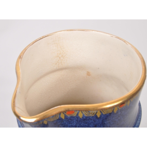 9 - A large 20th century Crown Pottery Bursley Ware Selah pattern jug. The jug having blue glaze with pa... 