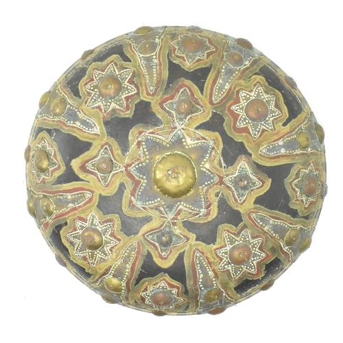 113 - A North Indian early 20th century brass & copper on wood circular shield dhal. The shield having a d... 