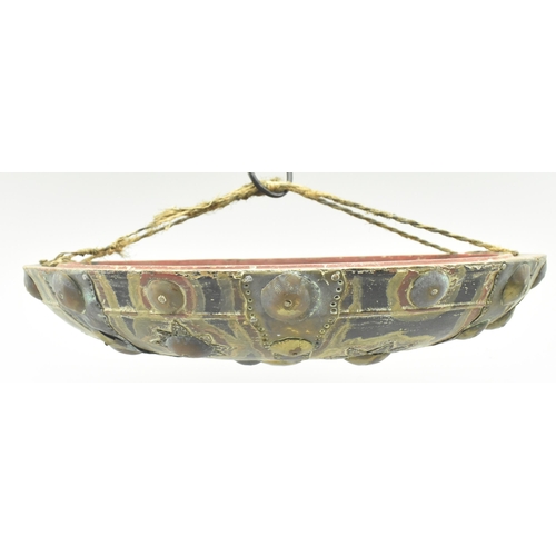 113 - A North Indian early 20th century brass & copper on wood circular shield dhal. The shield having a d... 