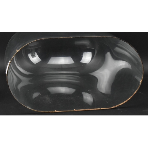 76 - An early 20th century glass dome. The large glass dome raised on a wine colour fabric lined black wo... 