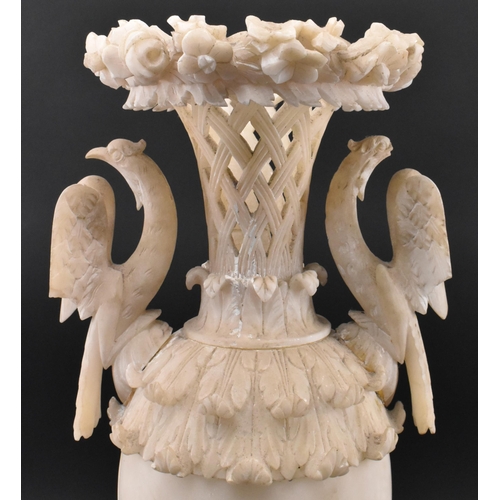 78 - A late 19th / early 20th century cream alabaster mantle piece vase. The vase having an intricately c... 