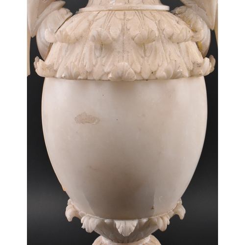 78 - A late 19th / early 20th century cream alabaster mantle piece vase. The vase having an intricately c... 