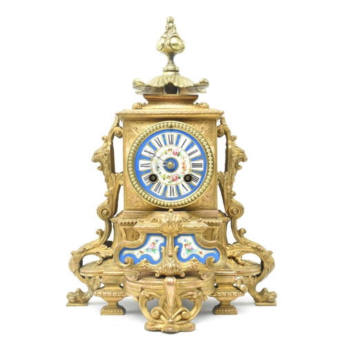86 - A French late 19th - early 20th century gilt metal two train mantel clock. The mantle clock featurin... 