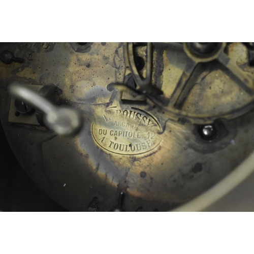 86 - A French late 19th - early 20th century gilt metal two train mantel clock. The mantle clock featurin... 